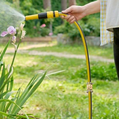 Person using a garden hose with Garden Hose Repair Connector Kit With Clamps For Three Quarter Or Five Eighth Inch Aluminum Hoses Includes Four Sets Of Male And Female Fittings And Washers Durable Aluminum Connectors With Stainless Steel Clamps to water plants.