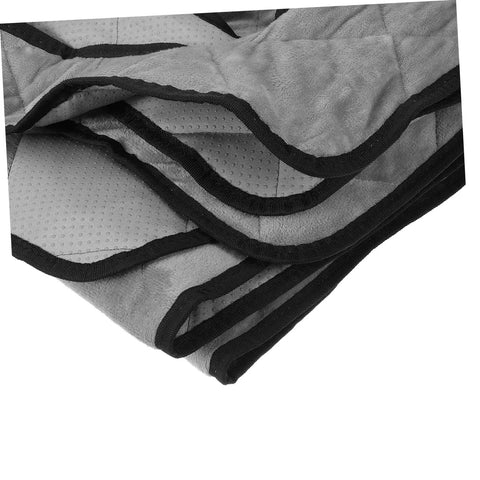Close-up of folded grey golf cart seat cover protector showing water-resistant material and black edging design.