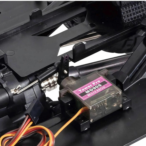 Close-up of One Tenth Scale RC Crawler Chassis Kit featuring micro servo, nylon frame, and gearbox components for DIY assembly.