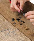 Hands using Pro Grade 61 Piece Pin Vise Drill Set With 50 Micro Twist Bits 1 To 3mm And 10 PCB Mini Bits for jewelry making.