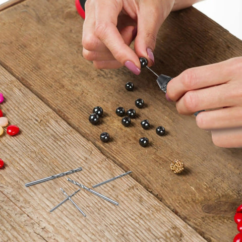 Hands using Pro Grade 61 Piece Pin Vise Drill Set With 50 Micro Twist Bits 1 To 3mm And 10 PCB Mini Bits for jewelry making.