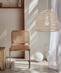 Rattan Chandelier Pendant Light Fixture With Handmade Basket Shade For Farmhouse Decor over chair and white curtain