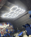 DIY Hexagon LED Garage Light Kit illuminating a gym with 11 grid layout, 46 tubes, 6500K ultra white, aluminum body visible.