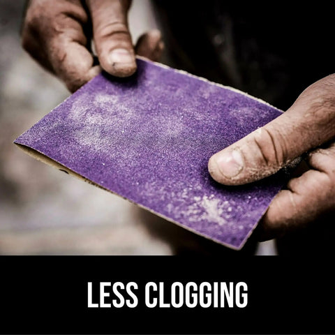 Hands holding a Pro Grade 9x11 Purple Sandpaper Set Of 20 120 Grit Clog Resistant Abrasive during woodworking.