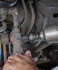 Mechanic using 13 Piece One Half Inch Drive 6 Point Impact Socket Set SAE Heavy Duty CrMo Steel in automotive repair