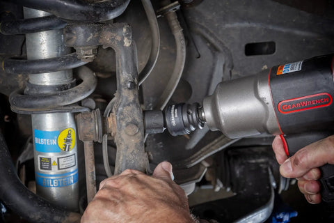 Mechanic using 13 Piece One Half Inch Drive 6 Point Impact Socket Set SAE Heavy Duty CrMo Steel in automotive repair