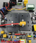 Top view of Gnarly Rc Connector Soldering Jig For Xt90 Xt60 Ec5 T Plug with clamps and various connectors on a workstation.