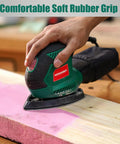 Hand using Compact Electric Detail Sander With 14,000 OPM on wooden surface, demonstrating efficient dust collection system