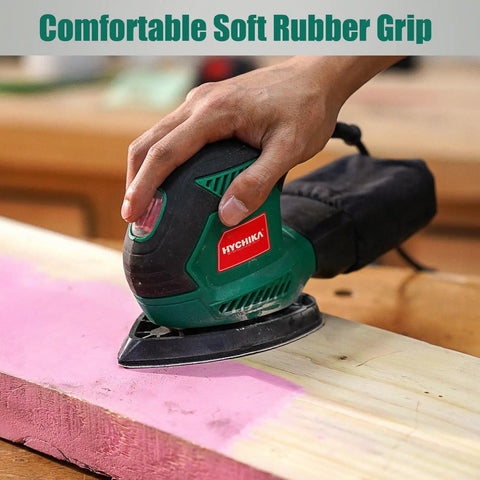 Hand using Compact Electric Detail Sander With 14,000 OPM on wooden surface, demonstrating efficient dust collection system