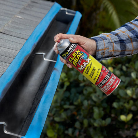 Person spraying gutter with clear rubber sealant, illustrating Two Pack 17 Oz Clear Rubber Sealant Spray That Stops Leaks Instantly