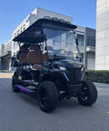Hella Comfy 6 Seater Electric Golf Cart With Roof LED Light Bar sleek black exterior and diamond stitched leather seats.