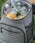 Kickass Heavy Duty Insulated Cooler Backpack With Leakproof Thermal Core And Adjustable Padded Straps For Camping Beach Hiking Keeps Snacks Ice Cold No Sweat filled with ice, drinks, and oranges.