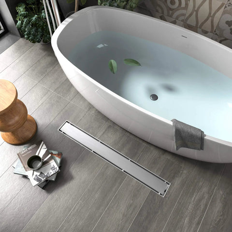 Bathroom with a bathtub and 24 Inch Brushed Nickel Linear Shower Drain Built Tough From 304 Stainless Steel That Will Not Rust Up In Wet Bathrooms