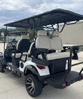 High Capacity Six Passenger Electric Golf Cart Featuring Rear Flip Seats Quiet Motor Drive with plush padded upholstery.