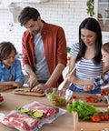 Family preparing meal with Precut Food Saver Vacuum Bags 150 Pcs Set for Meal Prep and Sous Vide on kitchen counter.