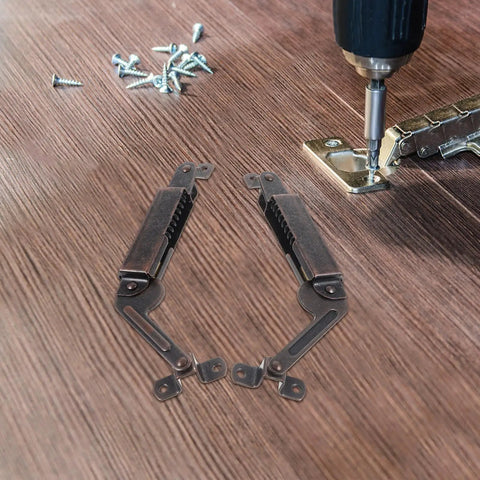 Heavy Duty Spring Lid Stay Hinges With Sweet Antique Red Iron Finish Tough As Nails Cabinet Hardware on wooden surface with screws.