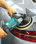 7-Inch Polisher With Pro Grade Variable Speed Dial used on car trunk for detailing, showing blue body and rubberized loop handle