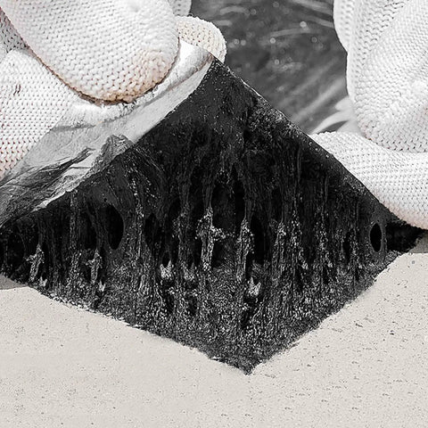 Close-up of Rock Solid Asphalt Roof Shingles Repair Tape 2 Mm Thick Aluminum Foil showing adhesive layer for leak sealing.