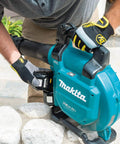 User attaching battery to Game Changing Cordless Leaf Blower Kit Equipped With A Brushless Motor Pumping 473 CFM And 120 MPH Air.