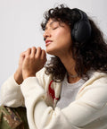 Person wearing Crusher Evo Wireless Bluetooth Headphones with Dope Multi Sensory Bass, noise isolating over-ear fit.