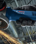 Heavy Duty 4 Inch Angle Grinder With Slick Paddle Switch For Tough Metal Cutting, sparks flying during grinding.