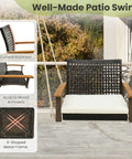 One Person Outdoor Porch Swing With Metal Frame And Soft Cushioned Seat Wicker Style Chair Ropes And Hooks Included PE Rattan Swing in off white with curved backrest and acacia wood armrests.