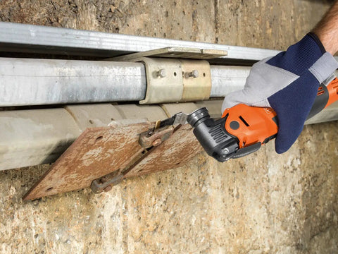 Person using Starlock Plus E Cut Carbide Pro Saw Blade TiN Coated for cutting metal panel