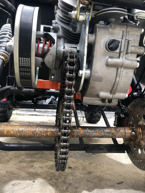 Forward Reverse Gearbox Kit For Go Karts With 11 To 18 HP Engines installed on vehicle, showing chain and sprocket detail