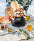 Stovetop Tea Kettle 3.2 Quart Stainless Steel Whistling Teapot With Wood Pattern Handle on outdoor table setting