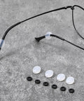 Six Piece Eyeglass Repair Kit With Glasses Temple Grips And Silicone Hinge Tighteners To Give Your Specs A Solid No Sweat Grip Plus Compact Screwdrivers For A Breeze Quick Fix That Works Like A Charm All Day. Display of silicone temple grips and rubber sleeves.