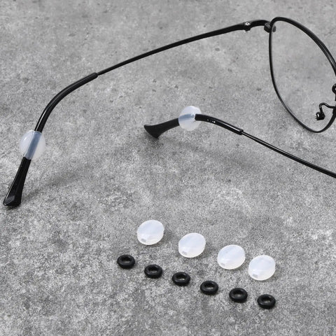 Six Piece Eyeglass Repair Kit With Glasses Temple Grips And Silicone Hinge Tighteners To Give Your Specs A Solid No Sweat Grip Plus Compact Screwdrivers For A Breeze Quick Fix That Works Like A Charm All Day. Display of silicone temple grips and rubber sleeves.