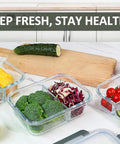 Glass Meal Prep Containers Set With Two Compartments 36 Oz Each Premium Borosilicate Glass Upgraded Snap Lock Lids shown with fresh vegetables