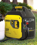 4000-Watt Dual Fuel Portable Inverter Generator RV Ready With Quiet Technology And CO Shield Auto Shutoff next to propane tank