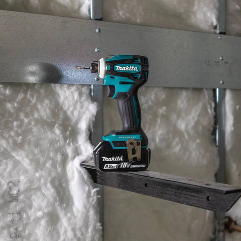 18V LXT Brushless Cordless Hammer Drill And Impact Driver Combo Kit with 5.0Ah batteries on metal framework