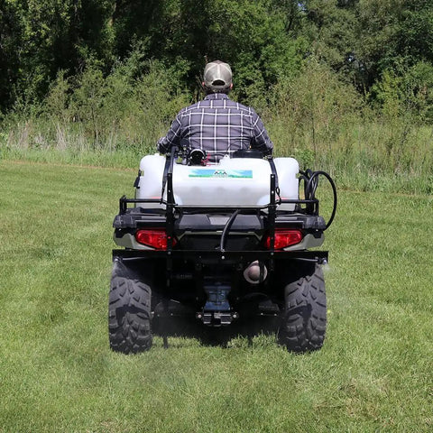 Person operating ATV with Beefy 15 Gallon ATV Broadcast Sprayer With 7 Ft Swath, 2.2 GPM Pump, 70 PSI Max on grassy field