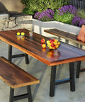 Outdoor dining setup with wooden table and benches featuring 16 Inch Black Iron Table Leg Set Of 2 For Dining Tables.