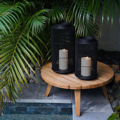 Outdoor Lantern With Realistic LED Candle For Patio, 12 Inch Black Metal Modern Farmhouse Style Lantern on round table by pool