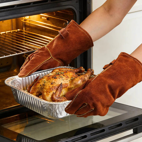 Person wearing 14 Inch 932F Heat Resistant Cowhide Leather Welding Gloves For Grill Pros And Home Cooks With Reinforced Palm, placing roast in oven