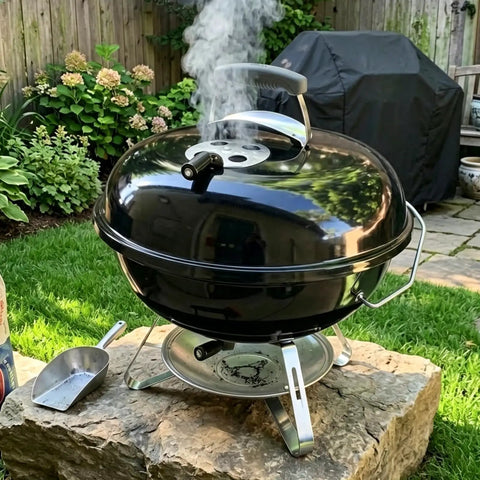 Black kettle grill with Cool Touch Damper Handle for Smokey Mountain WSM Kettle Grill, steam visible in a garden setting