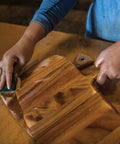 Person applying Top Tier Food Grade Mineral Oil With Natural Citrus Extract For Cutting Boards And Butcher Blocks 8 Oz Kitchen Conditioner.