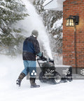 Porch Light With Built In Outlet GFCI No Fuss Outdoor Wall Sconce Lantern with snowblower and snow-covered landscape