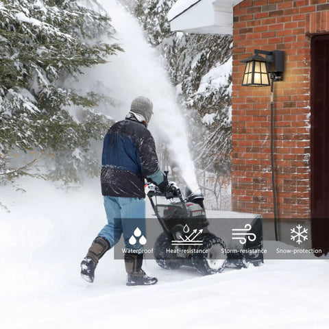 Porch Light With Built In Outlet GFCI No Fuss Outdoor Wall Sconce Lantern with snowblower and snow-covered landscape
