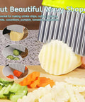 Front view of stainless steel 2-in-1 crinkle cutter and fry cutter slicing a potato into crinkle fries.