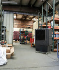 Industrial Swamp Cooler With 22000 CFM And 46 Gallon Water Tank in a warehouse setting, providing cool airflow among shelves.