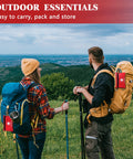 Two red mini first aid kits attached to blue and tan hiking backpacks in an outdoor meadow.