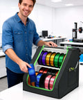 Person in workshop using Heavy Duty 3D Printer Filament Storage Box With 21 Spool Capacity, 2-Tier Filament Rack Organizer, stable trapezoid frame