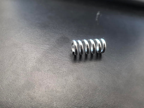 Close-up of a metal spring for Durable Plastic Air Compressor Regulator Knob 1370001 Replacement For Sanborn Craftsman Coleman PowerMate