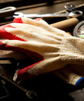 Economical String Knit Latex Dipped Palm Gloves With Nitrile Coated Fingers For General Purpose Work on a workbench