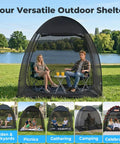 Pop Up Screen Tent 6x6 Feet Black Mesh Gazebo With Peaked Roof in use at a park with two people inside.