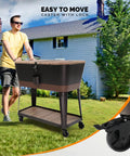 Man pushing 80 Quart Rolling Patio Cooler Cart With Blackboard, Built In Bottle Opener, Drainage System And Extra Storage Cabinet.